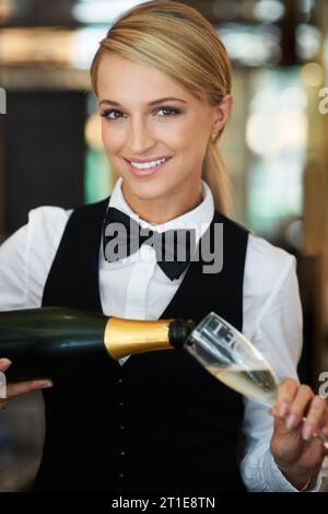 Champagner, Glas und Porträt einer Kellnerin in einem eleganten Restaurant, einer Veranstaltung oder einem Abendessen. Happy, Lächeln und junge Butlerin aus Australien pour Stockfoto