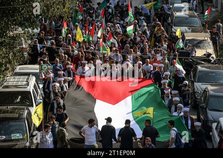Beirut, Libanon. Oktober 2023. Libanesische Demonstranten tragen in Solidarität mit den Palästinensern eine riesige palästinensische Flagge, während die Kämpfe zwischen israelischen Truppen und Militanten der palästinensischen Gruppe Hamas fortgesetzt werden. Marwan Naamani/dpa/Alamy Live News Stockfoto