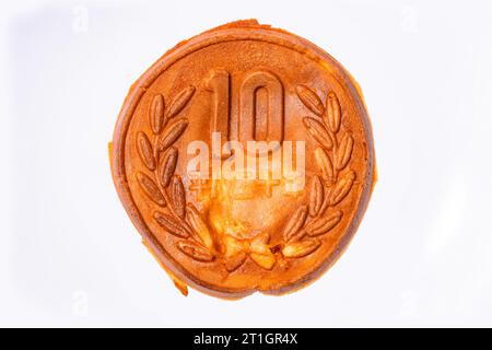 Nahaufnahme eines Pfannkuchens in Form einer japanischen 10-Yen-Münze, der ein Kauteig voller Käse ist, der den essbaren 10-Won-Münzen nachempfunden ist Stockfoto