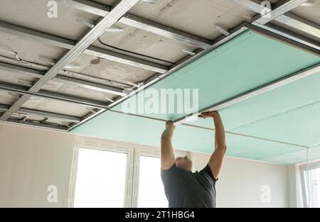 Drywall Installers. Men holding a gypsum board figured cut Stockfoto