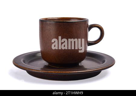 Braune Tonbecher auf einer Untertasse auf weißem Hintergrund Stockfoto