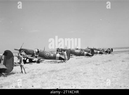 Royal Air Force - Italien, auf dem Balkan und in Südosteuropa, 1942-1945. Supermarine Spitfire Mark VCs von Nr. 352 Squadron, das erste Jugoslawische Einheit in der RAF gebildet werden, bei Canne, Italien, für Ihre erste Operation vorbereitet wird, Begleitung einen Jagdbomber Angriffe auf Ziele in Jugoslawien. Hinweis der Jugoslawischen nationale Kennzeichnungen auf dem Flugzeug, bestehend aus einem roten Stern auf der Mitte der RAF roundel und auf der Zentralen weißen Teil des Schwanzes Streifen überlagert. Stockfoto