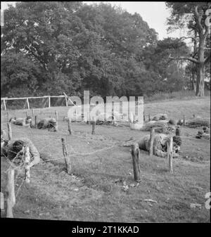 Erste US-Armee Rehabilitationszentrum - Erholung und Ausbildung bei 8 Erholungsheim, Stoneleigh Park, Kenilworth, Warwickshire, Großbritannien, 1943 Auszubildende bei der 8 Erholungsheim, Stoneleigh Park, der vor kurzem zu einer Besoldungsgruppe befördert wurden, testen Sie sich selbst, um zu sehen, wenn Sie wirklich voll sind. Hier Sie kriechen durch eine Reihe von Stacheldraht Tunnel, die von den Teilnehmern im Rahmen eines schwierigen Parcours aufgebaut. Stockfoto