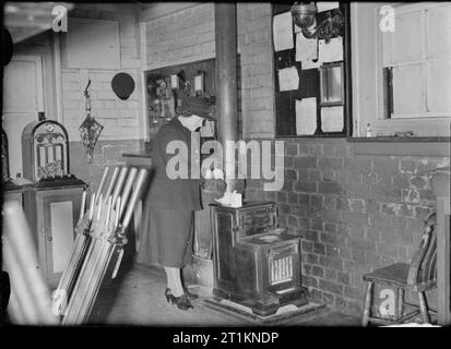 Naher Osten Sergeanten Frau Einweisende's Job-Leben Als Eisenbahn Signalwoman, Molland, Devon, England, UK, 1943, um 11 Uhr, Signalwoman Daisy Koch selbst macht eine Tasse Tee auf dem Herd in der Ecke, um das Fenster "Signal" im Molland in Devon. Sie ist auf die Frühschicht heute, und begann um 5:15 Uhr. Sie wird bis 1:20 Uhr. Stockfoto