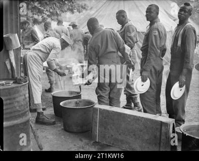 Sieg Marchers Camp in London - Unterkünfte in Kensington Gardens, London, England, UK, 1946 Männer von verschiedenen afrikanischen Regimenter Warteschlange für ihre Mahlzeit am Mittag ihre tented camp in Kensington Gardens, London. Stockfoto