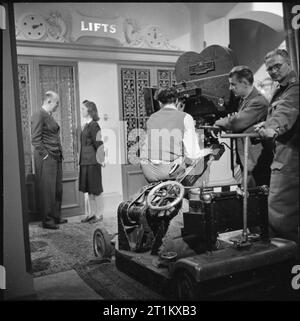 Geburt eines Sterns - Alltag für Schauspielerin Muriel Pavlow, England, UK, 1945 Schauspielerin Muriel Pavlow spricht mit Regisseur Lawrence Huntington am Set des Films "Nacht Boot bis Dublin", in Welwyn Garden Studios gemacht. Die kameraleute sind die Durchführung einer Film Test auf eingestellt und kann eindeutig auf der rechten Seite des Fotos zu sehen. Gemäß der ursprünglichen Beschriftung, sowie die Leitung der Film, Lawrence Huntington schrieb auch das Drehbuch. Stockfoto