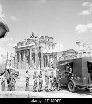 Deutschland unter alliierter Besatzung britische Soldaten Warteschlange für Tee an NAFFI Mobile Kantine Nr. 750 neben dem Brandenburger Tor, Berlin. Dieser Wagen war der erste mobile NAFFI in Berlin zu betreiben. Stockfoto