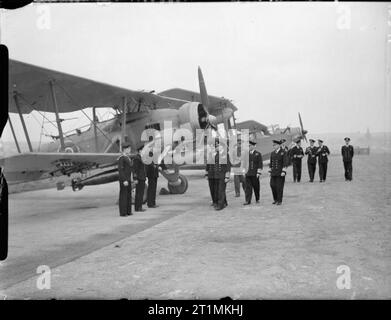 Die Royal Navy während des Zweiten Weltkriegs HM König George VI in der Uniform eines Admiral der Flotte Inspektion Fairey Swordfish Flugzeuge und Personal während seiner viertägigen Besuch der Home Fleet in Scapa Flow. Stockfoto