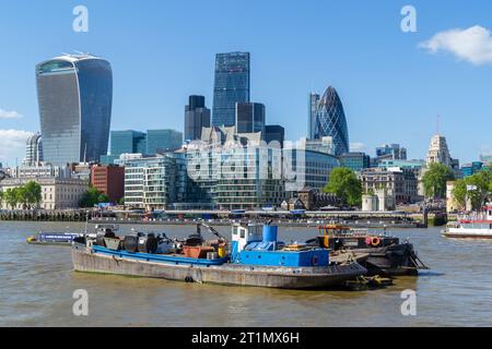 London, Großbritannien - 16. Mai 2015: Binnenschiffe auf der Themse vor dem Tower of London und Walkie Talkie und Gherkin Building. Stockfoto