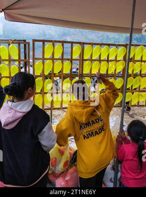 Can Cau Market, Vietnam. Patrons spielen Spiel, werfen Darts auf Ballons. Provinz Lao Cai. Stockfoto