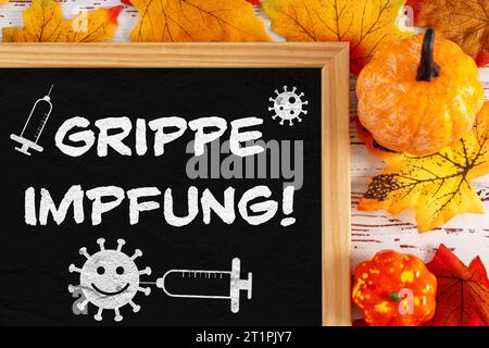 15. Oktober 2023: Grippeschutz Impfung Symbolbild, Tafel neben Herbstlaub mit Text Grippeschutz Impfung FOTO MONTAGE *** Grippeschutz Impfung Symbolbild, Tafel neben Herbstlaub mit Text Grippe Impfung FOTOMONTAGE Credit: Imago/Alamy Live News Stockfoto