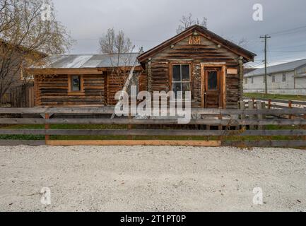 Historische Blockhütte mit Leiter und Zaun in Dawson City, Yukon, Kanada Stockfoto