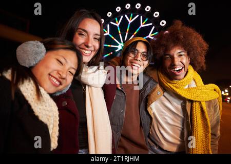 Porträtgruppe glückliche Generation Z-Menschen, die in der Winternacht ein Selfie-Foto machen, sehen lächelnd aus. Stockfoto