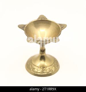 Ein sternförmiger Kerzenständer aus goldenem Messing, der für aarti-Gottesdienste in Tempelzeremonien isoliert verwendet wird Stockfoto