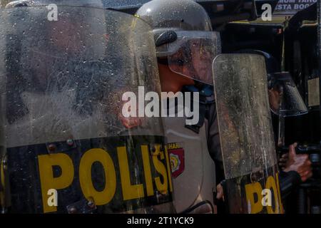 Polizeibeamte in Bogor City, Indonesien, tragen Helme und Schilde und bereiten sich darauf vor, während der Wahlsicherheit 2024 den Demonstranten der Simulation gegenüberzutreten Stockfoto