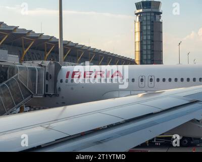 Santiago de Compostela, Spanien - 17. Juni 2023: Teile eines IBERISCHEN Flugzeugs vor dem Turm und dem Abflugstor des lokalen Flughafens. IBERIA i Stockfoto