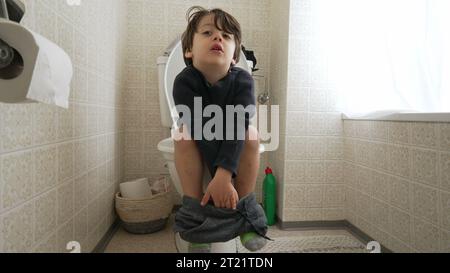 Kindertopf-Trainingskonzept, kleiner Junge auf Toilette sitzend Hygiene und Unabhängigkeit im Bad Stockfoto
