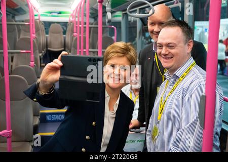 Aberdeen, Schottland, Großbritannien. Oktober 2023. Tag zwei der SNP-Jahreskonferenz, an dem die ehemalige erste Ministerin Nicola Sturgeon teilnimmt. Es folgte ein Medienrausch, bevor sie sich in den Konferenzsaal machte, um sich die Nachmittagsgeschichten anzuhören. Nicola Sturgeon trifft Teammitglieder von First Bus in einem neuen Elektrobus. Iain Masterton/Alamy Live News Stockfoto