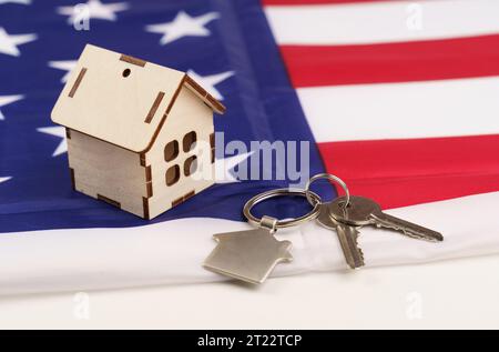 USA-Flagge und Schlüssel von zu Hause als Symbol für VA-Darlehen auf dem Schreibtisch. Stockfoto