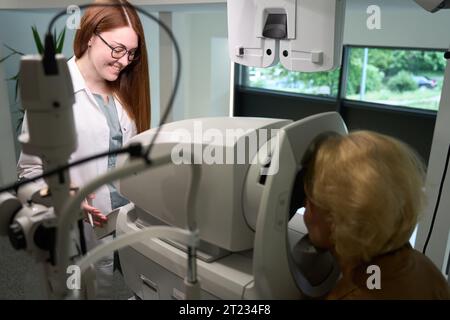 Frau in lässiger Kleidung bei einem Augenarzt-Termin Stockfoto