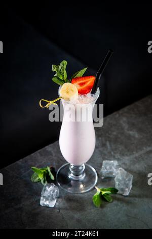 Milchshake mit Erdbeeren, Banane, Minze und Eis, Seitenansicht Stockfoto