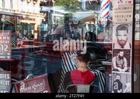 08.05.2018, Sydney, New South Wales, Australien - Blick durch das Schaufenster eines Friseurgeschäfts, in dem Kunden im Inneren betreut werden. Stockfoto