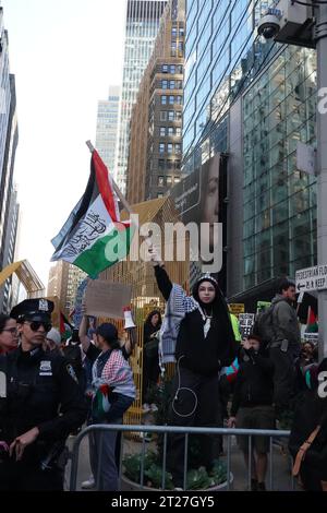 Ein pro-palästinensischer Demonstrant hält während der Demonstration eine Flagge. Pro-palästinensische Kundgebung am Times Square, wo Hunderte von der 42. Bis zur 38. St. versammelten, um gegen die brutale Bombardierung des Gazastreifens durch das israelische Militär zu protestieren, bei der unschuldige Bürger getötet werden und eine humanitäre Krise als Vergeltungsmaßnahme gegen den schrecklichen Terroranschlag der Hamas auf Israel verursacht wird, bei dem Hunderte getötet wurden. Stockfoto