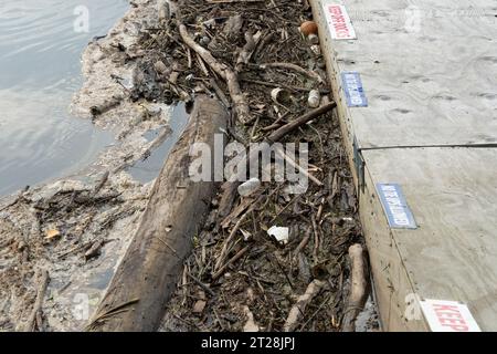 Müll und Verschmutzung sammeln sich an einem Dock in einem Fluss Stockfoto