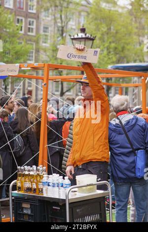 Person, die Corona-Bier auf dem Königstag verkauft. AMSTERDAM, NIEDERLANDE-28. APRIL 2019 Stockfoto