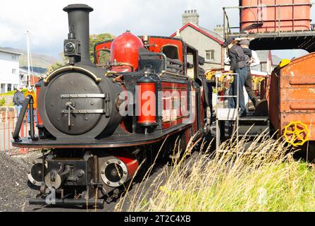Die David Lloyd George Dampflok der Ffestiniog Railway wurde am 23. Oktober in Porthmadog Harbour Station betankt. Beachten Sie die weibliche Stoker. Stockfoto