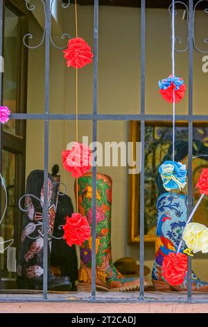 Handgefertigte bunte Cowboystiefel in einer Galerie im historischen Stadtzentrum von San Miguel de Allende, Mexiko. Stockfoto