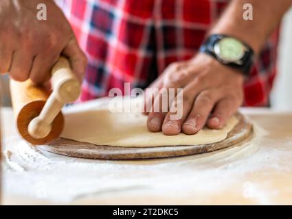 Details der Hände von Männern, die den Teig Rollen. Zubereitung zum Backen von traditionellem tschechischem Gebäck. Hausgemachte frische Speisen Stockfoto