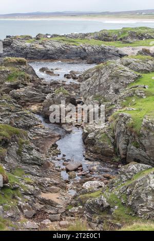 Spektakuläre Schluchten, Bögen und Seestapel prägen die Küste zwischen Kintra und Port Alsaig auf Islay. Stockfoto