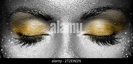 Schöne weibliche Augen mit Funkeln im Gesicht. Farbenfrohe Glitzer-Make-up im Kunstdesign Stockfoto