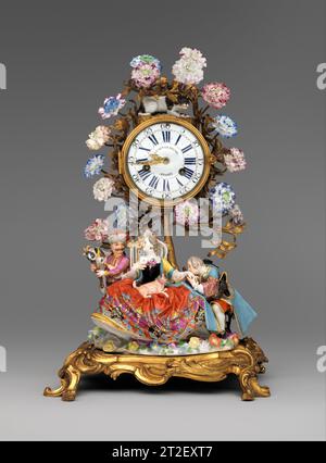 Manteluhr: Paul Gudin Le Jeune Französische Figurengruppe von Meissen Manufaktur Deutsche Blumen von Vincennes Manufaktur Französische Uhr ca. 1750, Figuren dekoriert ca. 1737/38 wurden die Materialien, die in Uhrkästen eingebaut werden konnten, von den Pariser Zünften eingeschränkt. Unternehmer, die als Marchands-Merciers bekannt sind, umgingen diese Regeln, indem sie Teile aus verschiedenen Quellen zusammenfassten, was zu so ausgeklügelten Uhren wie diese führte. Hier sind eine Porzellanfigurengruppe, bekannt als der Handkuss, und eine separate Figur eines Hofnarren mit Rokoko-vergoldeter Bronze zu sehen Stockfoto