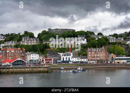 Die Hafenstadt Oban mit Hafenpromenade, Whisky-Destillerie und McCaig's Tower auf Battery Hill, Argyll and Bute, Schottland, Großbritannien Stockfoto