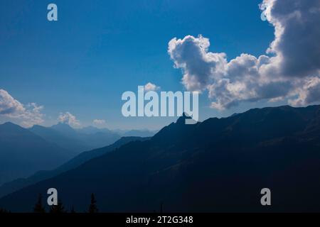 Bergszene mit Sonne hinter Wolken Stockfoto