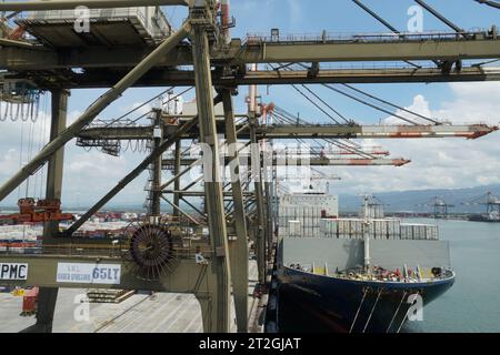 Ladungsbetrieb mit Portalkranen, die von Stauanlagen eines Containerschiffs betrieben werden, das vollständig mit weißen Kühlcontainern beladen ist. Stockfoto