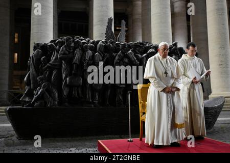 Vatikan, Vatikan. Oktober 2023. Italien, Rom, Vatikan, 2023/10/19 Papst Franziskus leitet ein Gebet für Migranten und Flüchtlinge, Teil der 16. Vollversammlung der Bischofssynode, vor Timothy Schmalz Bronze-Skulpturenkomplex „Engel unawares“ und dem Kreuz San Damiano, links, ein großes romanisches Zentrum, vor dem St. Franziskus von Assisi betete, als er vom Herrn den auftrag erhalten hat, die Kirche in St. Peter's Square im Vatikan Foto von VATIKAN MEDIA/Catholic Press Photo Credit: Independent Photo Agency/Alamy Live News Stockfoto