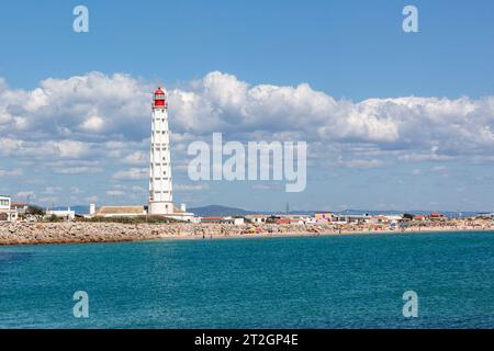 Leuchtturm, einige Häuser und Strand von Ilha do Farol, Culatra Barrier Island, Olhao, Algarve, Portugal Stockfoto