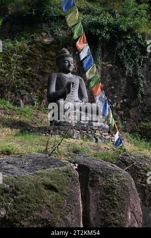 Buddha Statue und tibetische Gebetsfahnen vor dem Eingang zum Messner Mountain Museum bei Bozen, Italien *** Buddha Statue und tibetische Gebetsfahnen vor dem Eingang zum Messner Mountain Museum bei Bozen, Italien Stockfoto