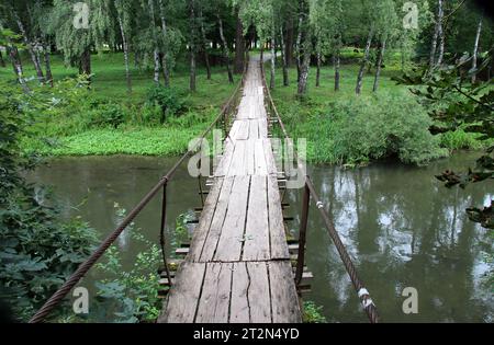 Eine hölzerne Brücke über einen kleinen Fluss Stockfoto