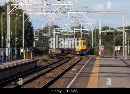 Northern Rail Class 319 Elektrozug in Kirkham und Wesham mit rotem LED-Signal und Fahrleitung Stockfoto