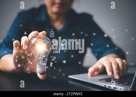 Handleuchte, die die Abschlusskappe zeigt, Internet-Bildung kreativ mit Symbol und studieren Arbeitswissen, Schülerschule, Training Learn Course. Stockfoto