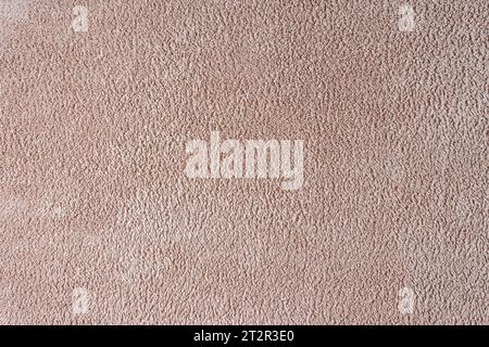 Frotteetuch, beige Handtuch Textur Hintergrund. Weiches flauschiges Textilbad oder Strandtuch. Draufsicht, Nahaufnahme. Stockfoto