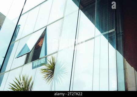 Atemberaubende Aufnahmen aus einem offenen Hochhausfenster, umrahmt von einem wunderschönen blauen Himmel und flauschigen weißen Wolken Stockfoto