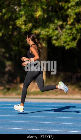 Schönes, schlankes und gebräuntes Mädchen, gekleidet in enger Sportbekleidung, mit Agilität und Freude mit Stil und perfekten technischen Bewegungen Stockfoto