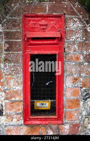 Broken Red (E II R) Briefkasten auf der Straße in Worthing, West Sussex Stockfoto