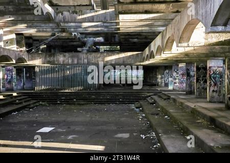 St. Peter's Semenary auf dem Anwesen Kilmahew in der Nähe von Cardross, Dumbarton, Schottland. Ein brachliegendes, brutalistisches Betongebäude in Wäldern, das mit Graffiti bedeckt ist Stockfoto