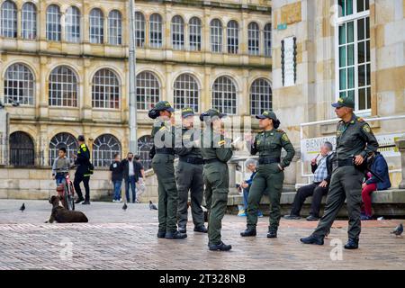 Bogota, Kolumbien - 1. Januar 2023: Mehrere Polizisten plaudern und essen Süßigkeiten auf der Plaza de Bolivar, dem Hauptplatz von Bogota Stockfoto